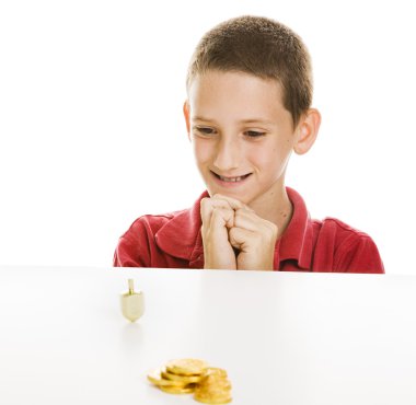 Boy Watching Dreidel Spin clipart