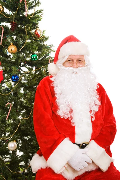 Santa sedí pod vánoční stromeček — Stock fotografie