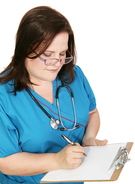 Krankenschwester macht sich Notizen — Stockfoto