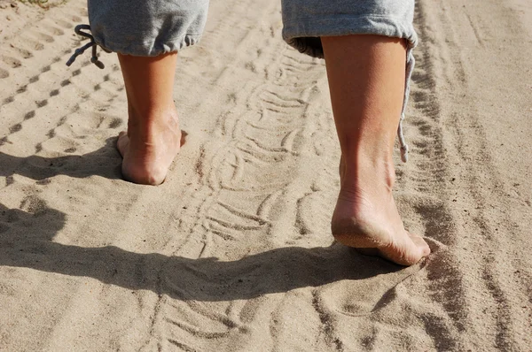 Grote voeten in het zand. — Stockfoto