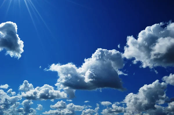 Beautiful blue sky and sun with clouds — Stock Photo, Image