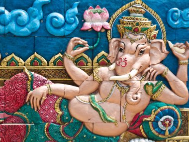 Golden Hindu God Ganesh on wall clipart