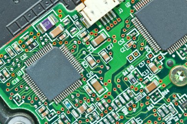 The modern printed-circuit board with electronic components macr clipart