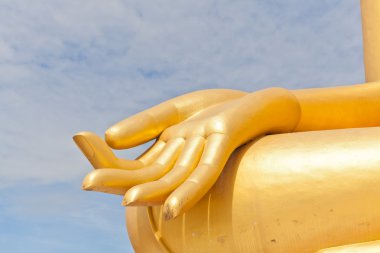 Big Golden Buddha hand statue in Thaland temple clipart