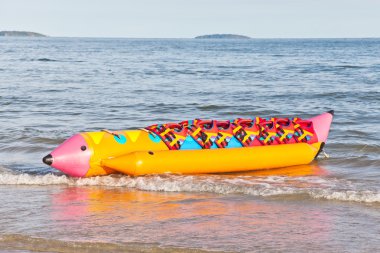 Colorful banana boat with life jacket clipart