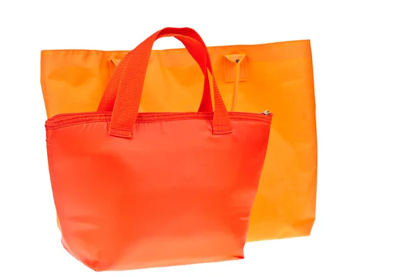 Barevné červené a oranžové bavlněné tašky na bílém pozadí izolované. — Stock fotografie