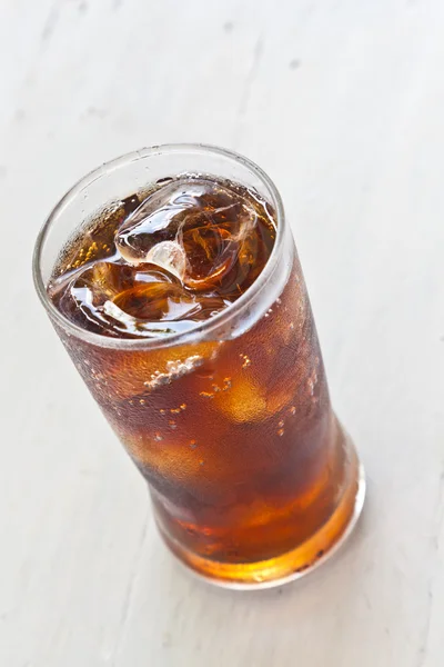 stock image Water, Fresh coke in glass, on white wood