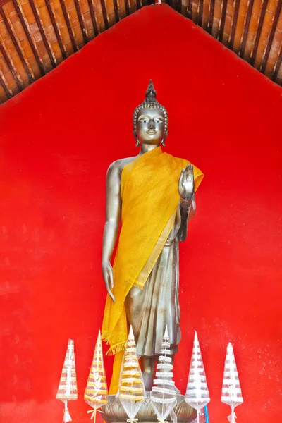 Будда, стоять на красном фоне, храм Таиланда — стоковое фото