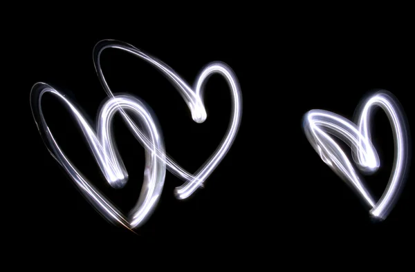 stock image Triplet Of Lightbrushed Hearts Against Black