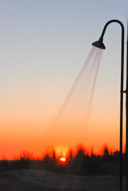 Outdoor Shower At The Beach DUring Sunset clipart