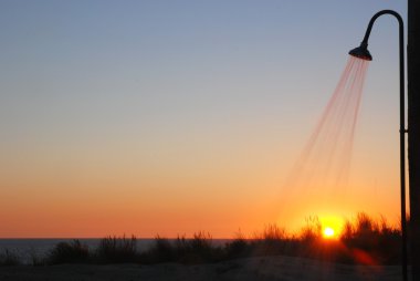 Shower At The Beach During Sunset Sunbathing Concept clipart