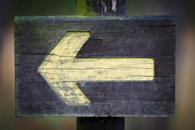 Wooden directional sign on the foothpath clipart