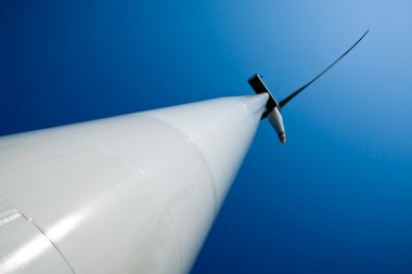 Power generating wind turbines and blue sky clipart