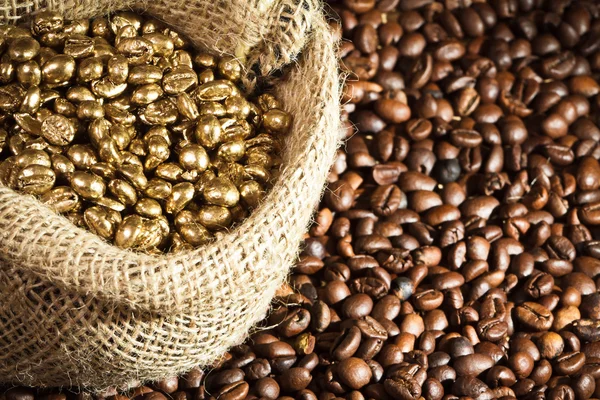 Golden coffee seeds on burlap coffee sack — Stock Photo, Image