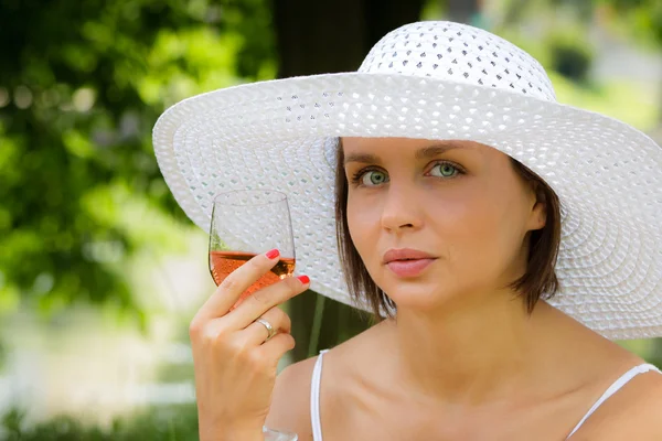 stock image Woman with lamp of wine on picnic