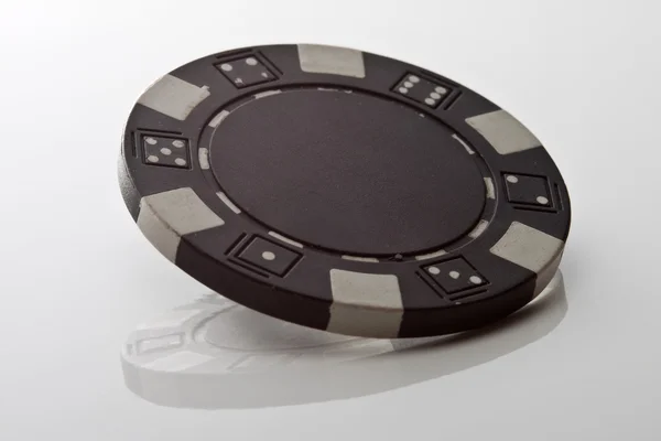 stock image Black chip on white reflection table