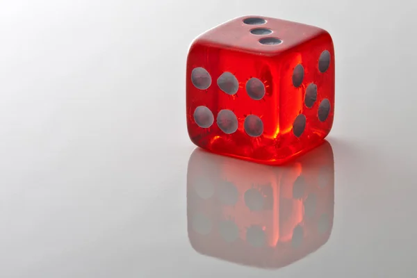 stock image Red dice on mirrored table