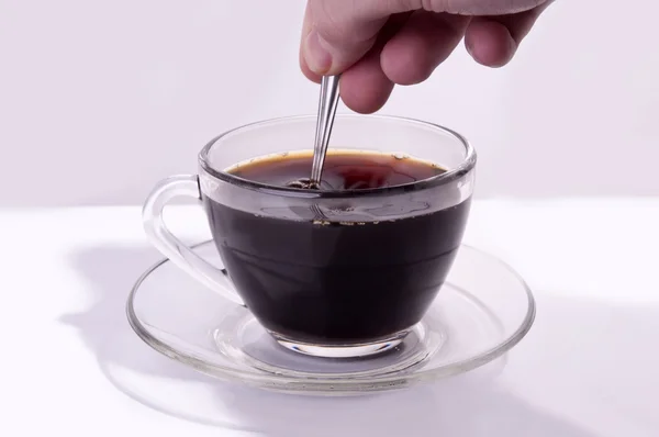 Schwarzen Kaffee umrühren Stockfoto
