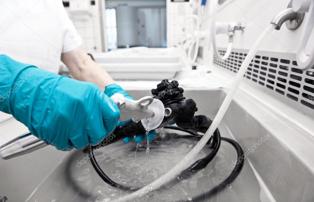 Hand with glove is cleaning hospita equipment
