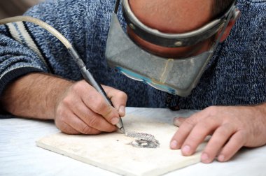 Engraver in stone table clipart