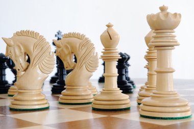 Chess pieces on wood board clipart