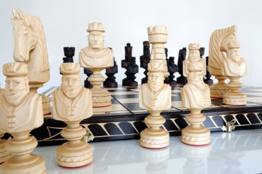 Chess pieces on wood board clipart