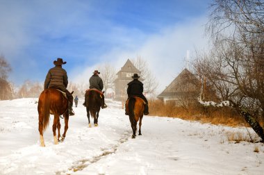 Riders in the winter landscape clipart