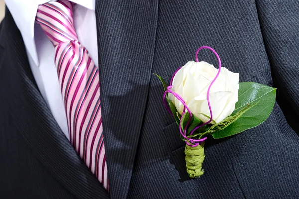 Groom in a wedding dress holding a white rose — Stock Photo, Image