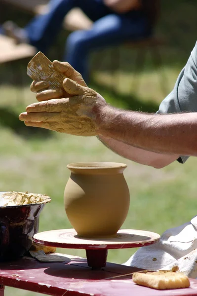 Hands of a potter, creating an earthen jar on the circle — Stock Photo, Image