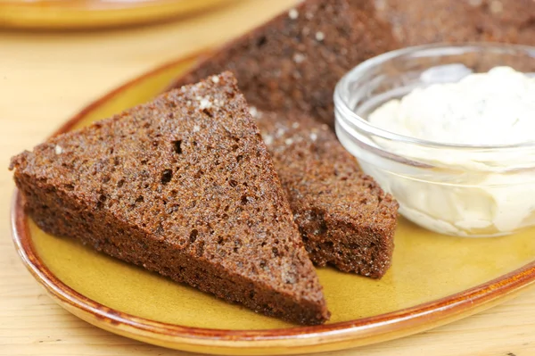 stock image Black bread toasts with garlic sauce on a plate