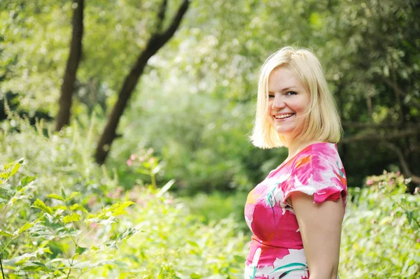 Adorable blond woman walks in the summer forest — Stock Photo, Image