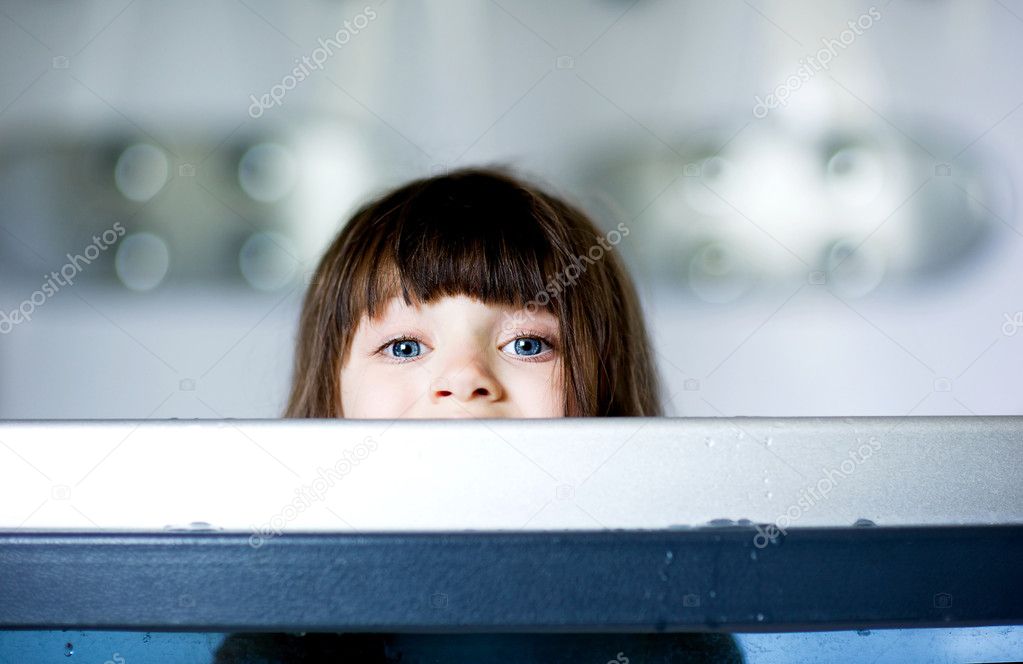 Child girl plays in a bathtub