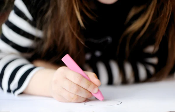 Young child girl in black draws picture for Halloween party — Stock Photo, Image