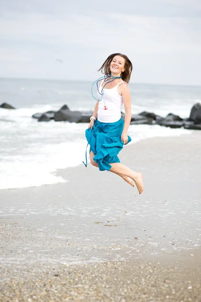Hermosa joven se divierte en la orilla del océano — Foto de Stock