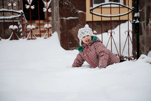 Adorable smiling child girl has fun in the snow — Stock Photo, Image