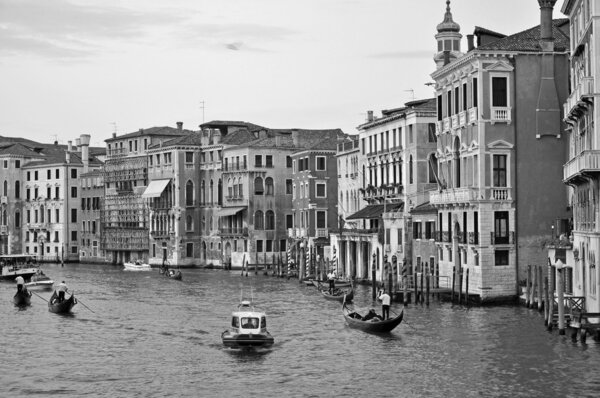 VENICE, ITALY - SEPTEMBER 27, 2009: Tourists enjoy a beauty of Venetian Grand Channel during gondola rides on September 27, 2009 in Venice.