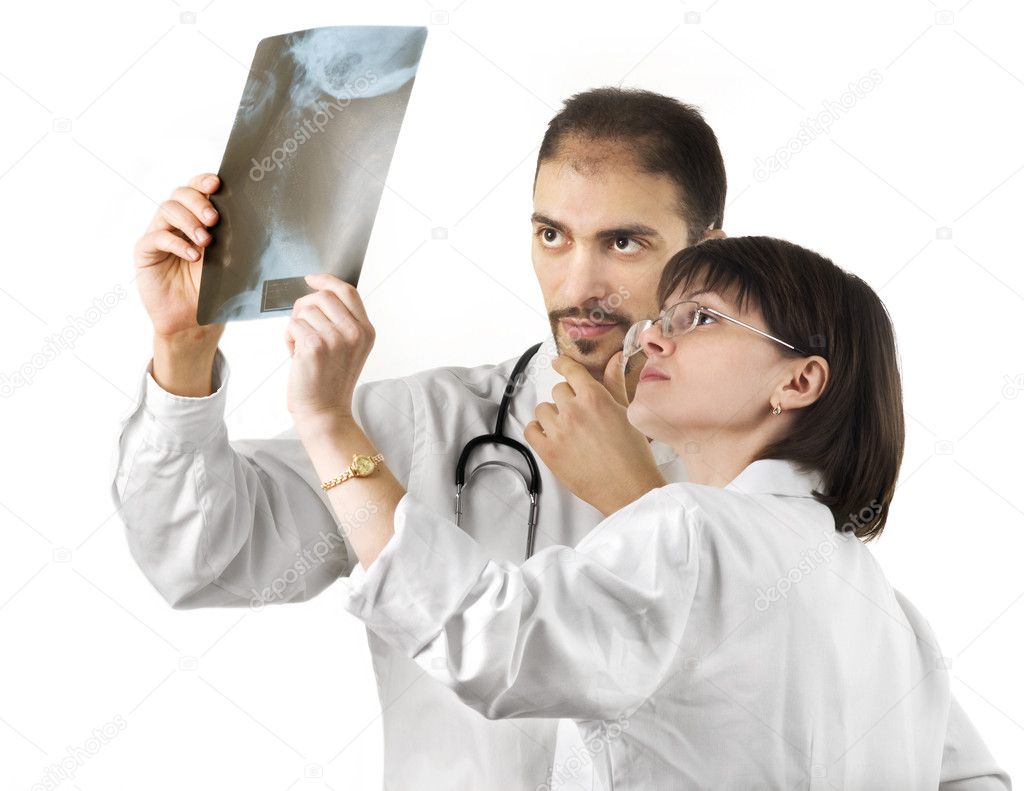 Two doctors watching an xray over a white background