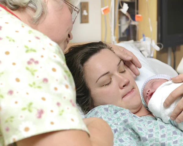 Mother and grandmother with newborn baby right after delivery — Stock Photo, Image