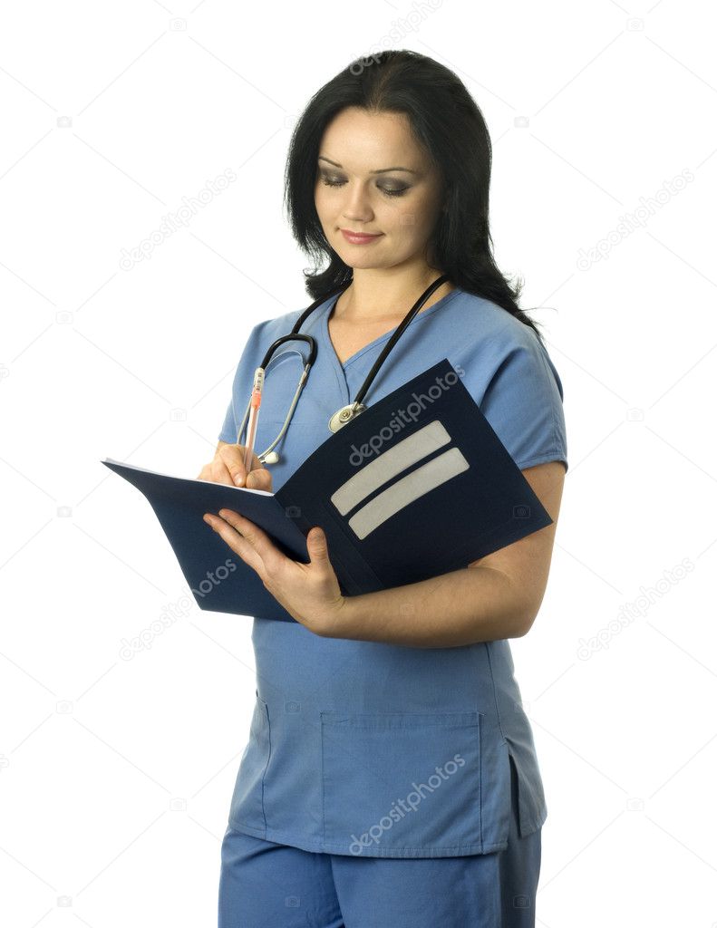 Beautiful female nurse writing medical record