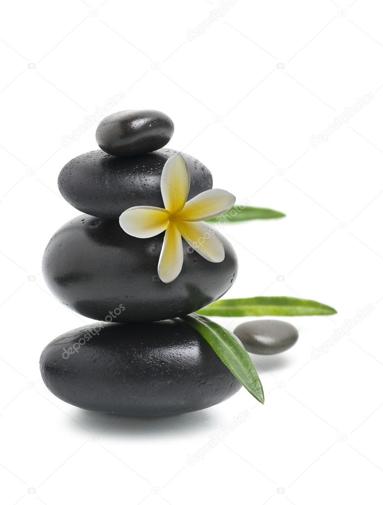 Spa still life, Stack of pebbles with yellow flower