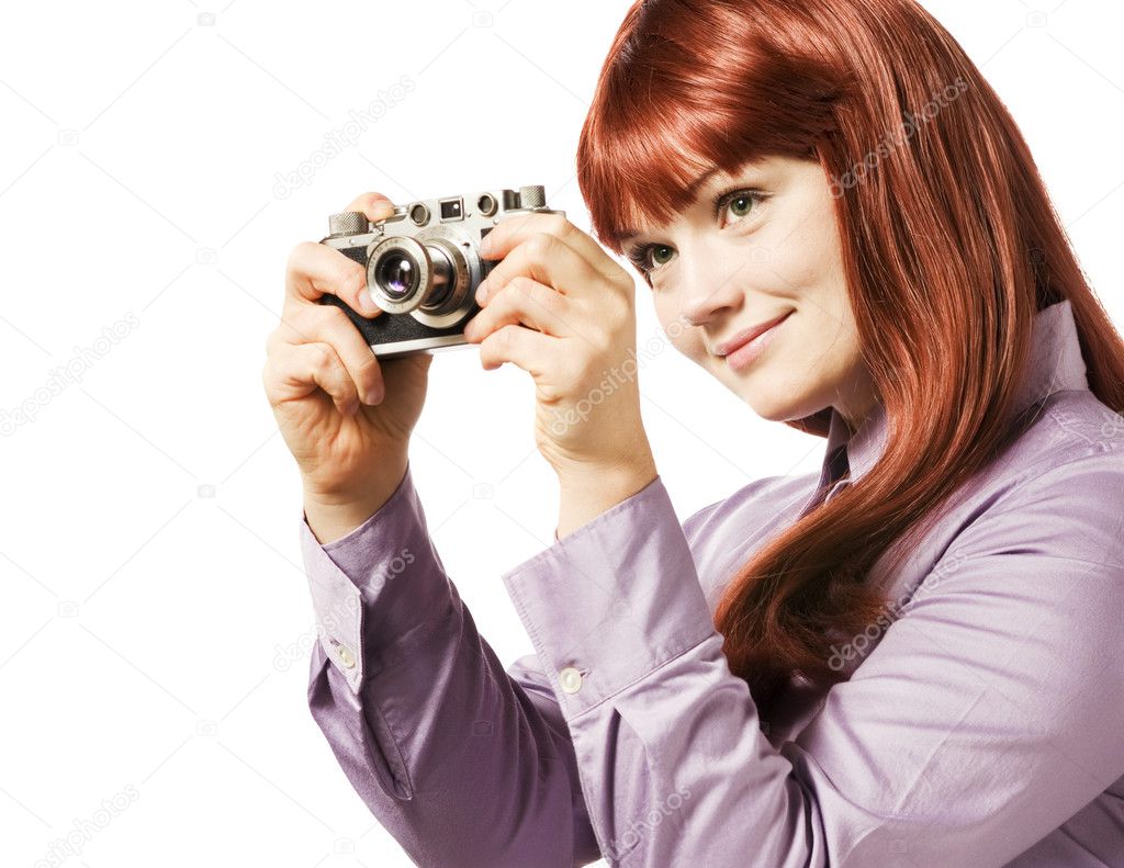Young woman taking picture with a retro camera