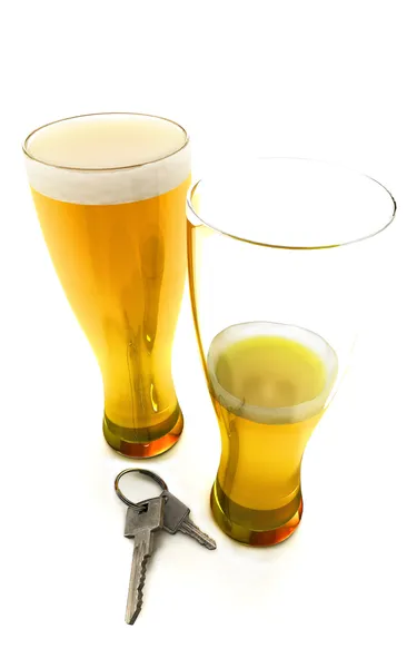 stock image Two beer mugs with car keys concept