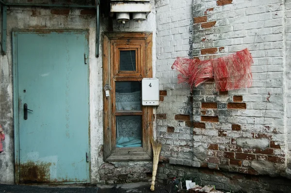 stock image The brick wall with a door and window