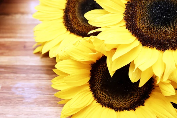 stock image Sunflowers on a wooden table