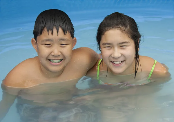 Fiú és lány a medence — Stock Fotó