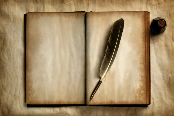 Quill on old book — Stock Photo, Image