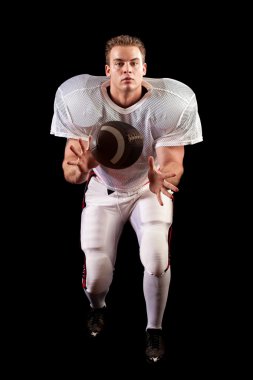 American football player. Studio shot over black. clipart