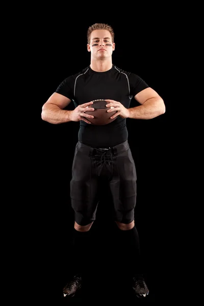 Jugador de fútbol americano. Estudio filmado sobre negro . — Foto de Stock