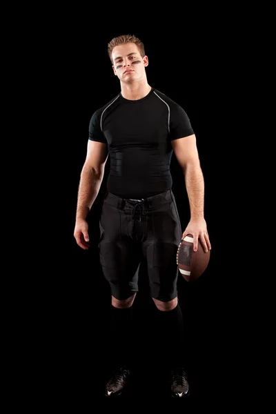 American football speler. studio opname over zwart. — Stockfoto