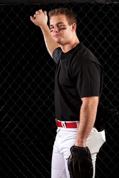 Young adult baseball player. Studio shot over black. — Stock Photo, Image